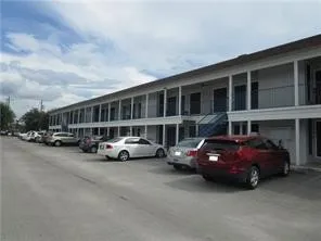 a car parked in front of a big house