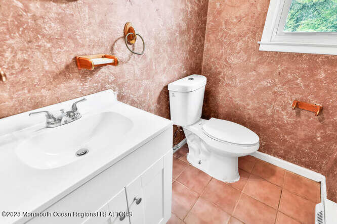407 Cook Road Jackson, NJ 08527 - Photo 13 of 25 a white toilet sitting next to a bathroom sink