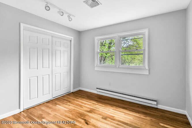 407 Cook Road Jackson, NJ 08527 - Photo 22 of 25 a view of empty room with wooden floor and fan