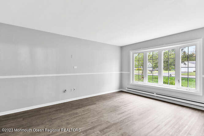 407 Cook Road Jackson, NJ 08527 - Photo 4 of 25 an empty room with wooden floor and windows