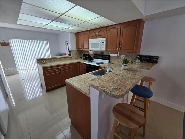 a dining room with furniture and a potted plant