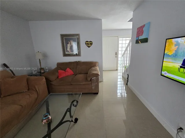 a view of a livingroom with workspace and a window