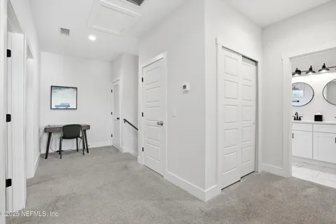 a view of a hallway with bathroom