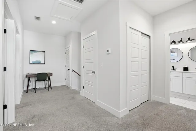 a view of a hallway with bathroom