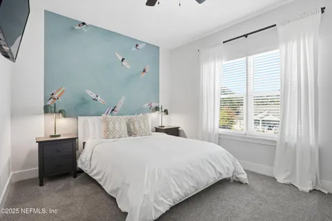 a bedroom with a bed and window