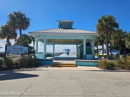 a group of palm trees in front of a building