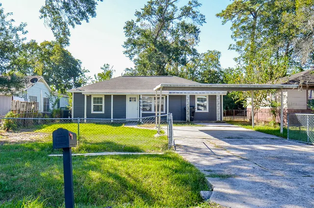 a front view of house with yard and outdoor seating
