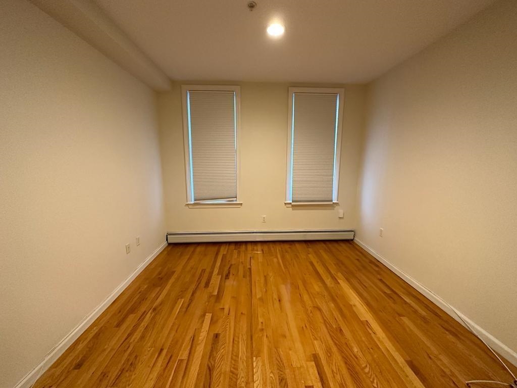 358 3rd Street, Unit 3R Hoboken, NJ 07030 - Photo 4 of 8 a view of room with window and wooden floor