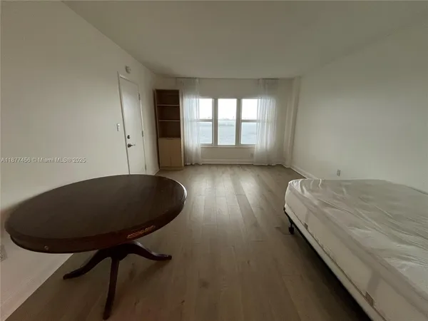 a bed room with a bed and a chair