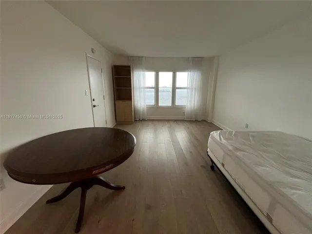 a bed room with a bed and a chair