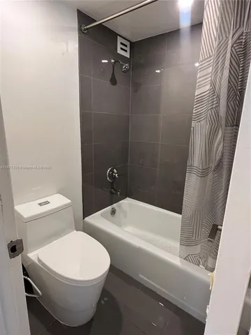 a bathroom with a toilet and a bathtub