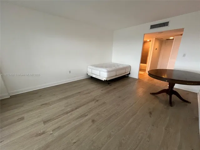 a view of a livingroom with lounge chair and couch