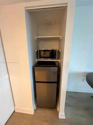 a kitchen with a refrigerator and a sink