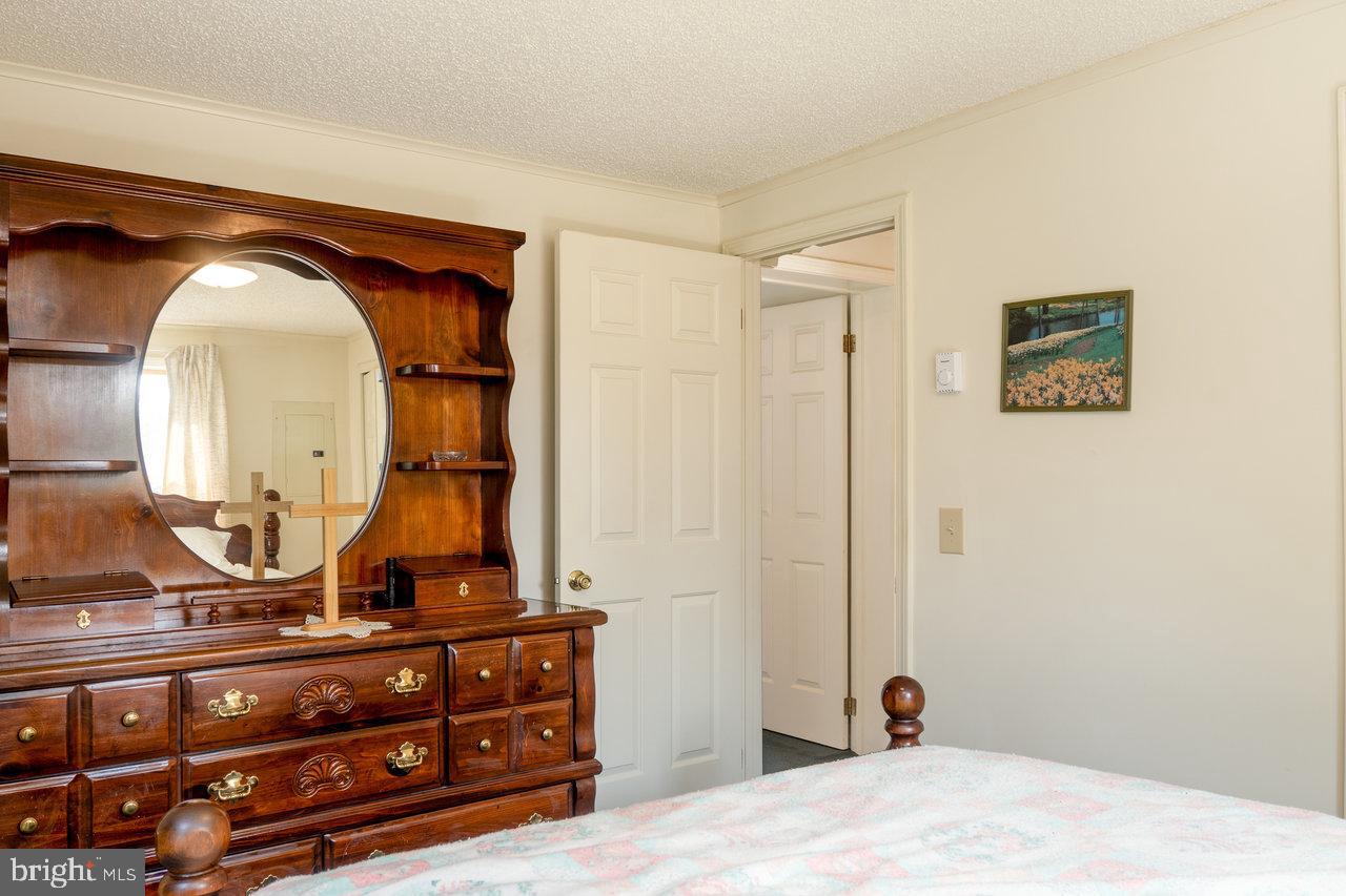 1529 Goodrich Road Stanley, VA 22851 - Photo 25 of 42 a bedroom with a bed and a mirror