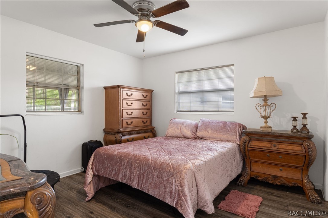 1140 South Highlands Avenue Inverness, FL 34452 - Photo 31 of 54 a bedroom with a bed and a chandelier