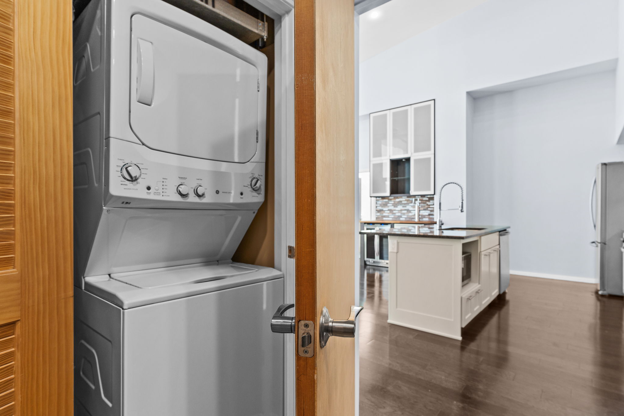 1600 Barton Springs Road, Unit 4602 Austin, TX 78704 - Photo 11 of 39 Washroom with stacked washer and clothes dryer and dark wood-style flooring