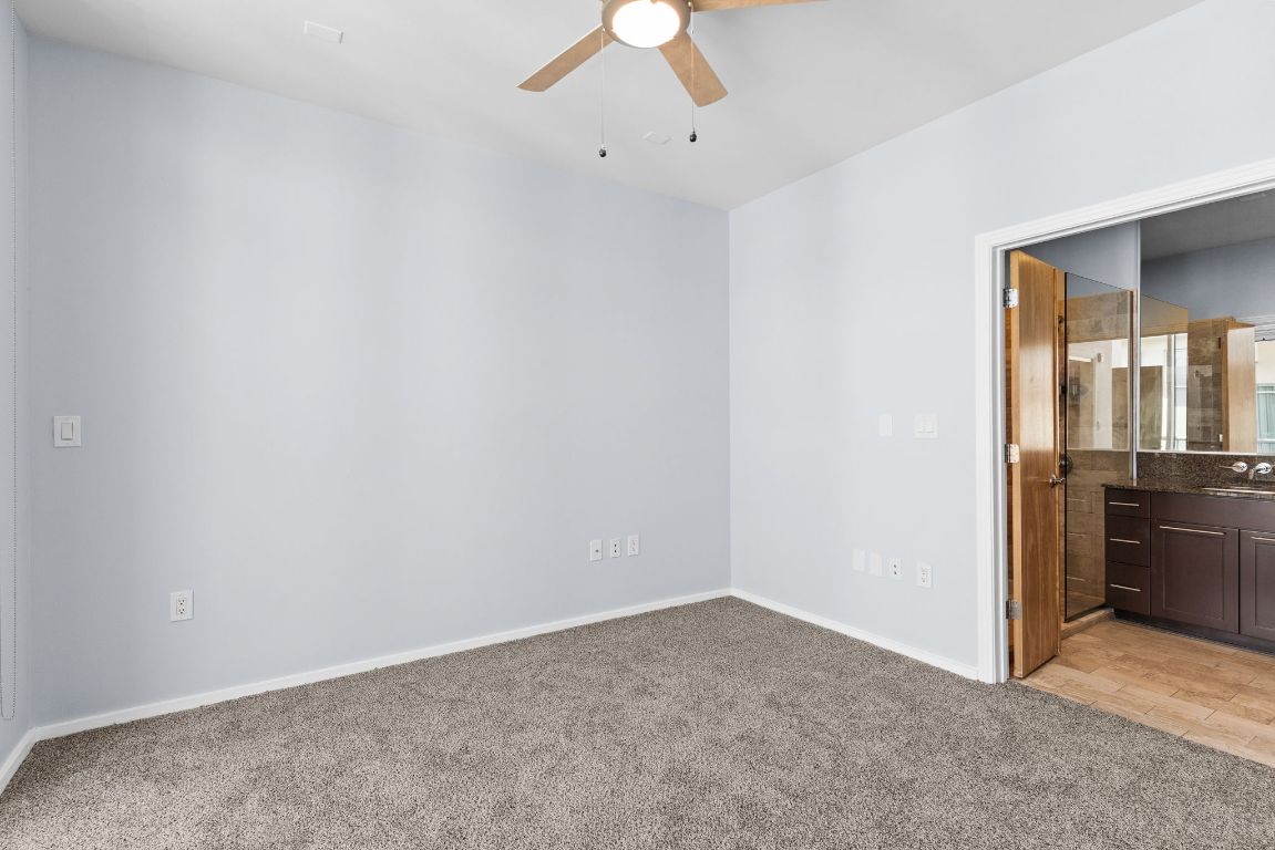 1600 Barton Springs Road, Unit 4602 Austin, TX 78704 - Photo 12 of 39 an empty room with a empty space and a ceiling fan