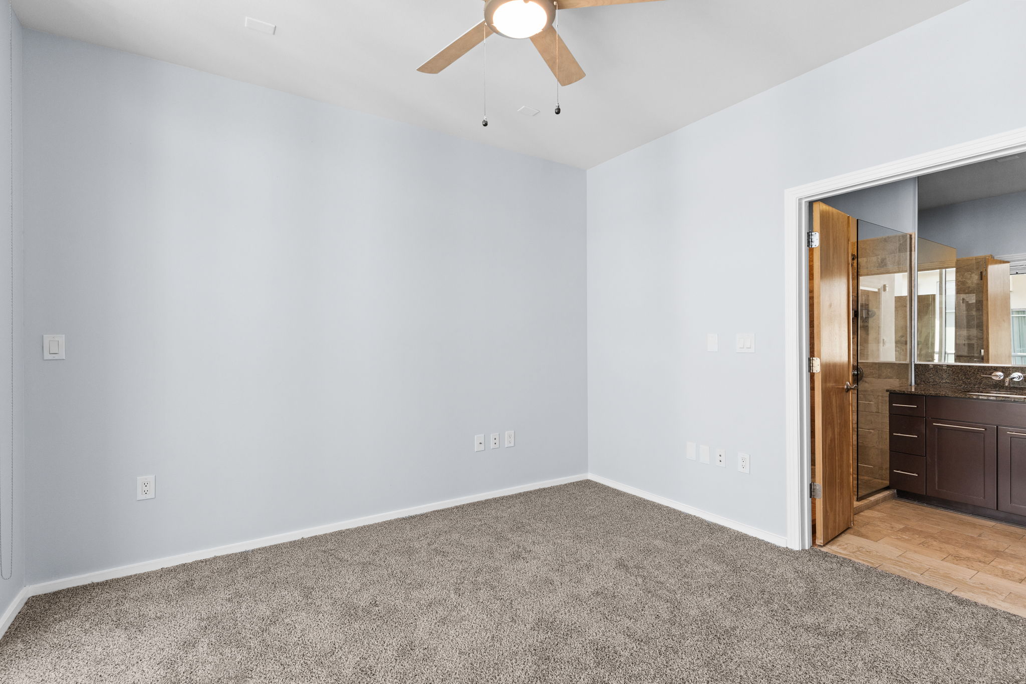1600 Barton Springs Road, Unit 4602 Austin, TX 78704 - Photo 12 of 39 Empty room featuring light carpet and a ceiling fan