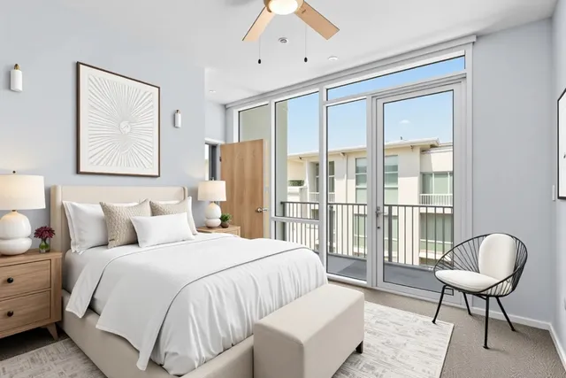 a bedroom with a bed and a large window