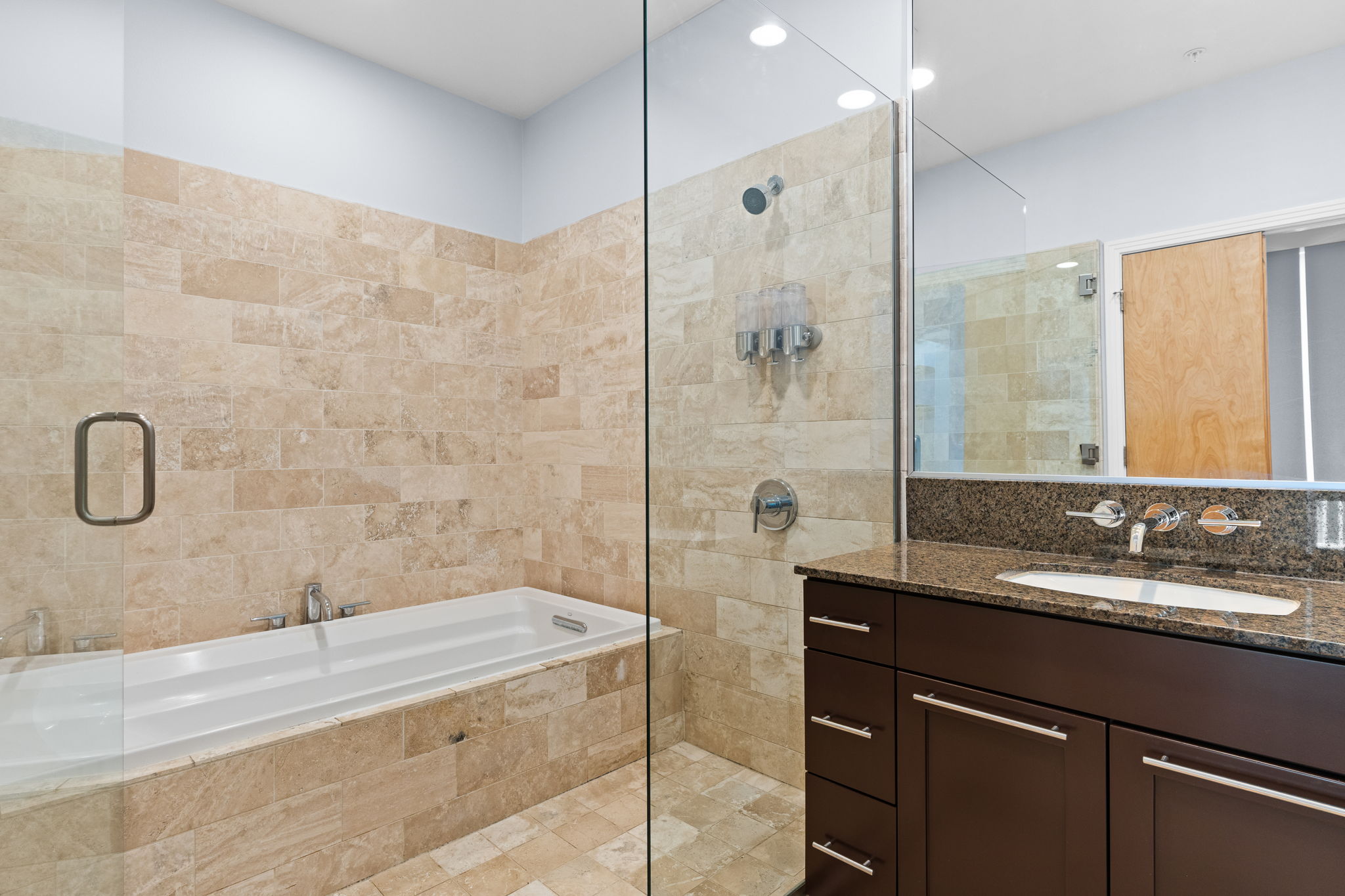 1600 Barton Springs Road, Unit 4602 Austin, TX 78704 - Photo 16 of 39 Bathroom featuring tiled shower, vanity, tiled tub, and tile walls