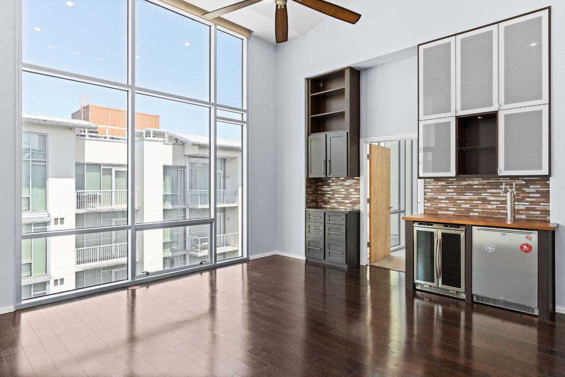 1600 Barton Springs Road, Unit 4602 Austin, TX 78704 - Photo 2 of 39 a kitchen with stainless steel appliances granite countertop a refrigerator a stove and a sink with wooden floor