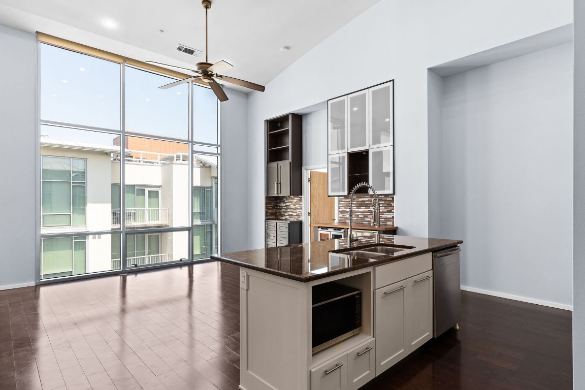 1600 Barton Springs Road, Unit 4602 Austin, TX 78704 - Photo 5 of 39 a kitchen with stainless steel appliances a stove and a large window