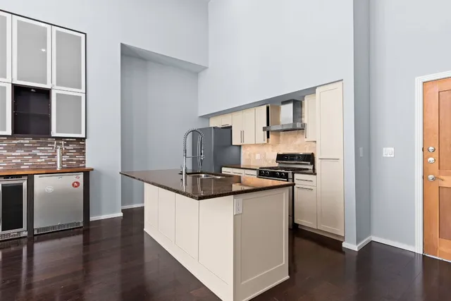a kitchen with stainless steel appliances granite countertop a stove and a refrigerator