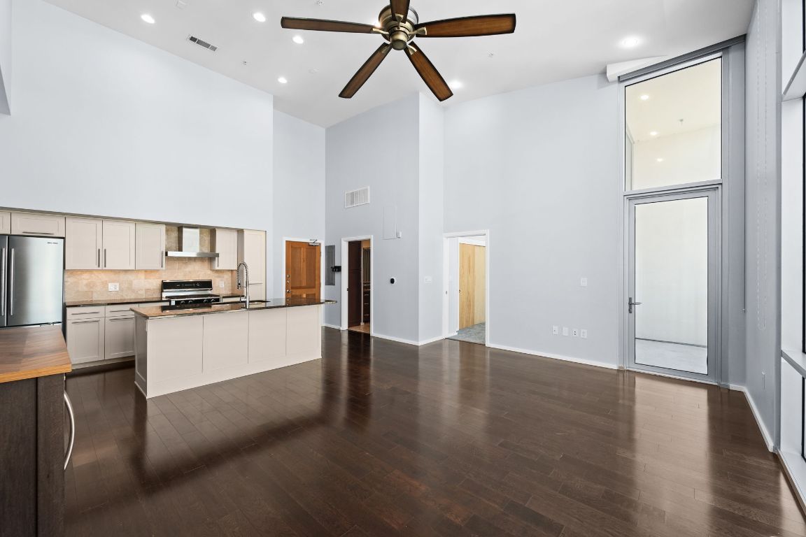 1600 Barton Springs Road, Unit 4602 Austin, TX 78704 - Photo 7 of 39 a view of a kitchen with a sink stove refrigerator and wooden floor