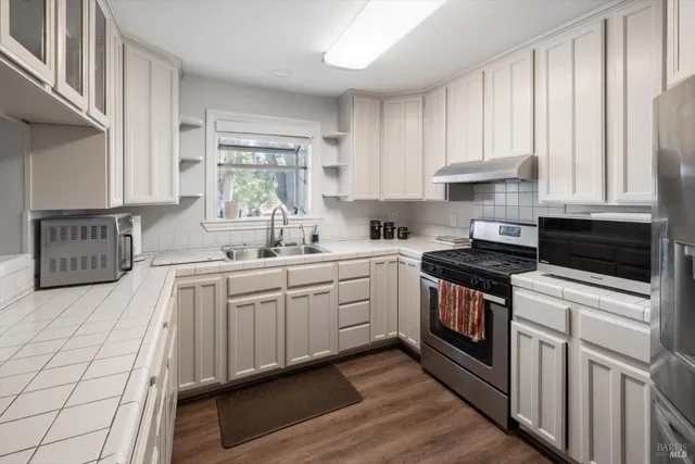 a view of a kitchen with utility and cabinets