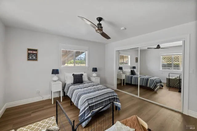 a bathroom with a granite countertop sink a toilet and a mirror