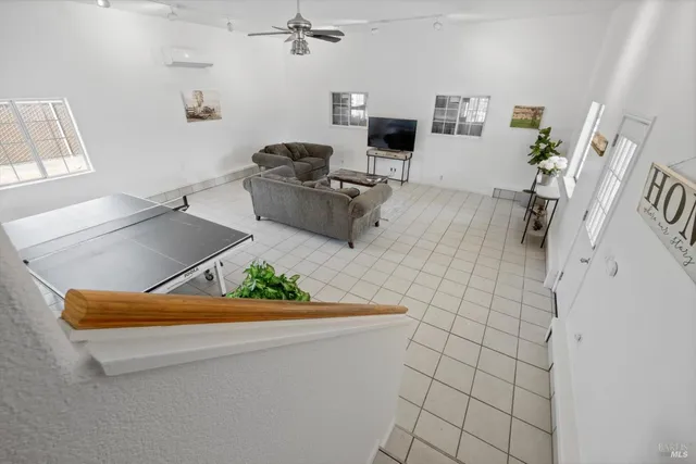 a living room with furniture and a chandelier
