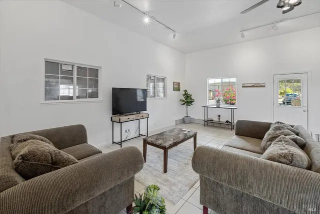 a living room with furniture and a flat screen tv