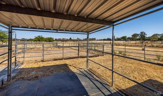 a view of a patio with chair and tables