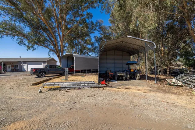 a view of a backyard with plants and outdoor seating