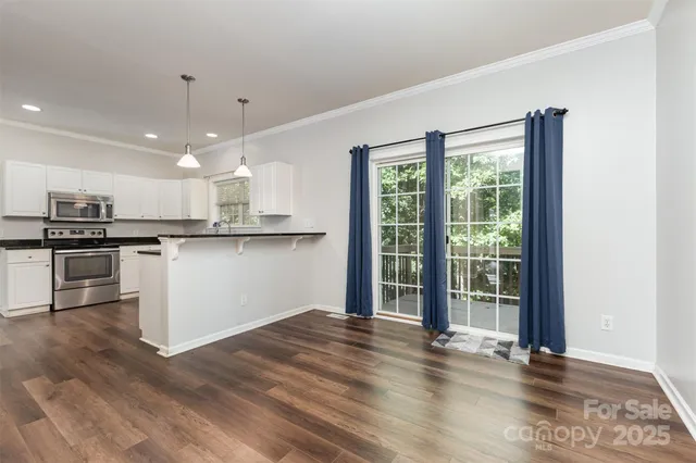 a kitchen with stainless steel appliances granite countertop a refrigerator and a stove top oven