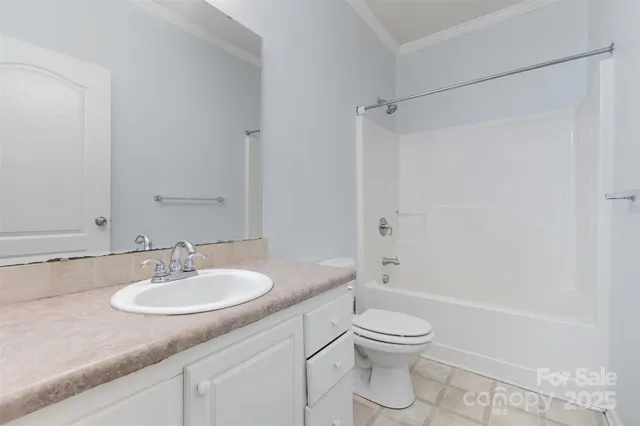 a bathroom with a granite countertop sink a toilet and shower