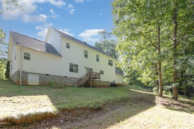 a view of a yard with large trees