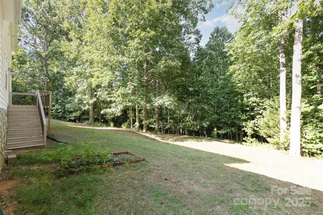 front view of house with a yard and potted plants