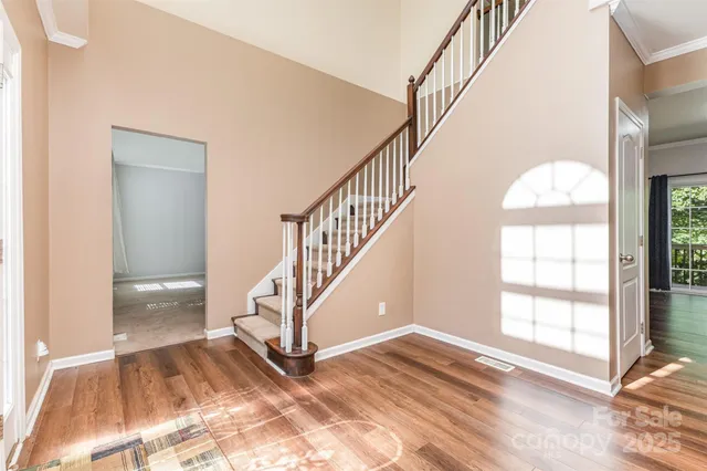 a view of entryway and hall with wooden floor