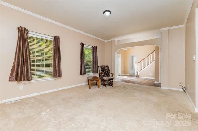 an empty room with windows and couch