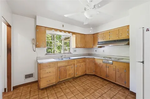 a kitchen with a sink cabinets and window