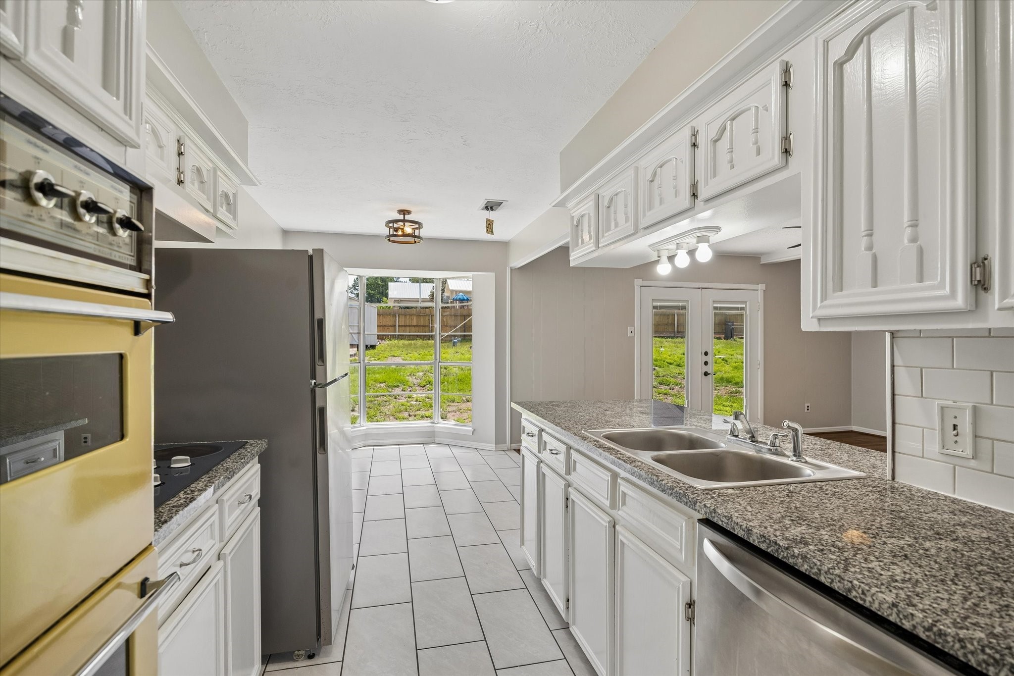 25114 Spring Ridge Drive Spring, TX 77386 - Photo 12 of 24 a kitchen with stainless steel appliances granite countertop a sink a stove and a refrigerator