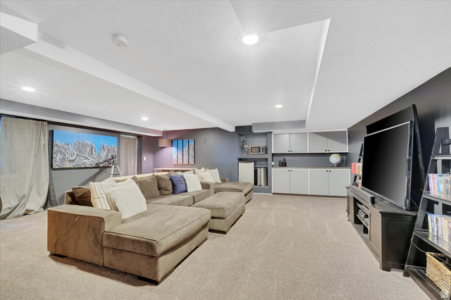 510 Spring Creek Road Providence, UT 84332 - Photo 33 of 97 Carpeted recreation room featuring recessed lighting, a built-in entertainment center, and integrated cabinetry with shelving