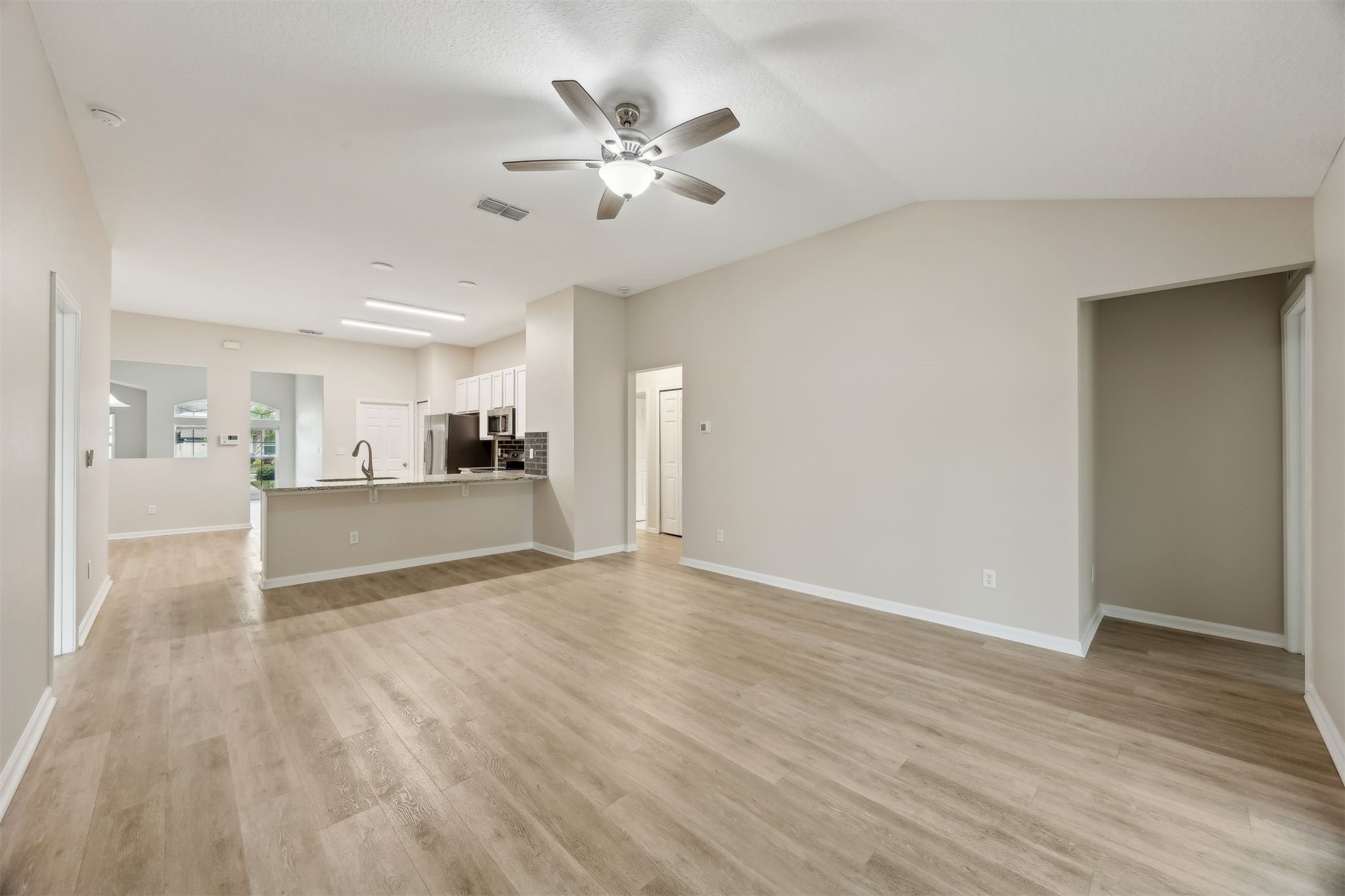 96735 Quartz Lane Yulee, FL 32097 - Photo 20 of 61 Family room to kitchen