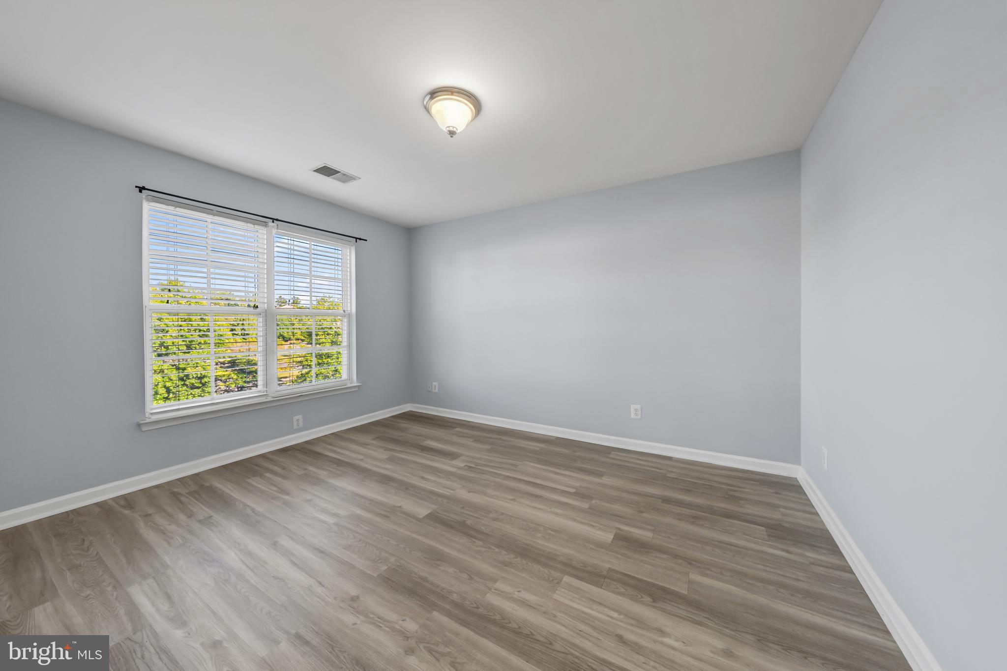9231 Ribbon Falls Loop Bristow, VA 20136 - Photo 28 of 40 a view of an empty room with wooden floor and a window