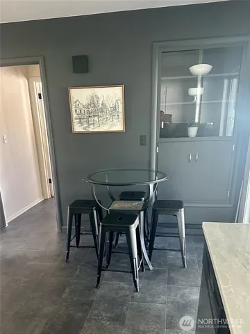 a balcony with table and chairs