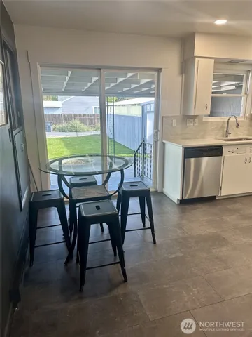 a dining room with furniture and a large window