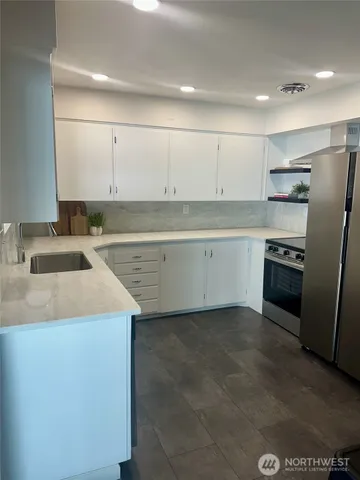a kitchen that has a sink and a stove in it