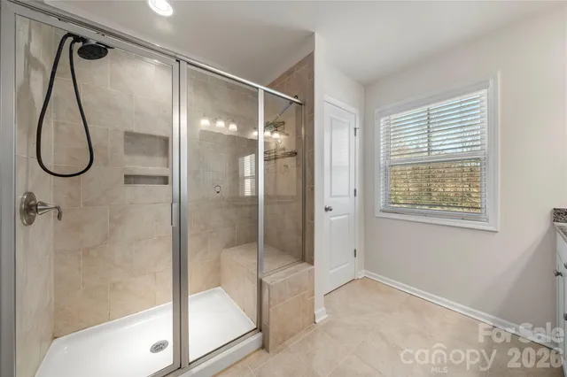 a bathroom with a glass shower door