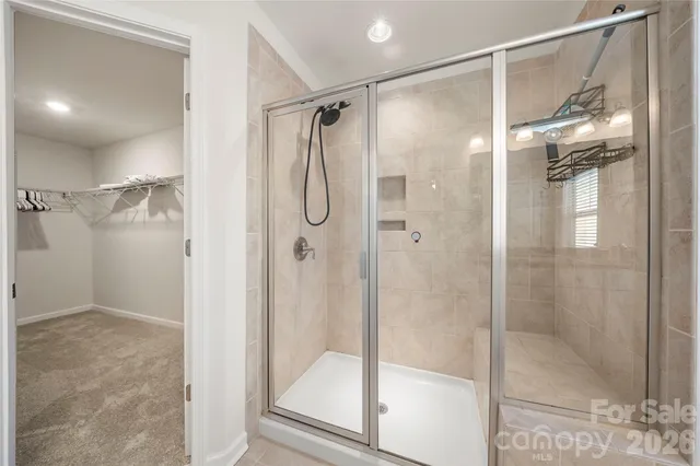 a bathroom with a glass door shower